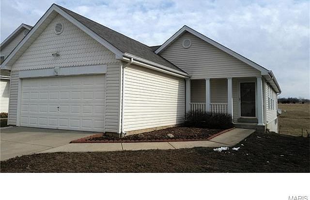 Cute vinyl sided ranch with covered front porch has great curb appeal!