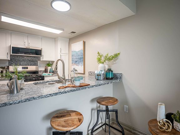 Bright kitchen with modern cabinetry and granite counters