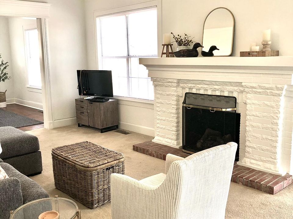 Spacious living room with Arts & Crafts fireplace, 9 foot ceilings, all new furnishings and 2 TVs in living & bedroom.