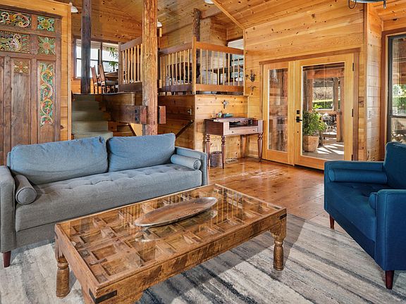 Open concept Living room with glass front doors and many architectural accents