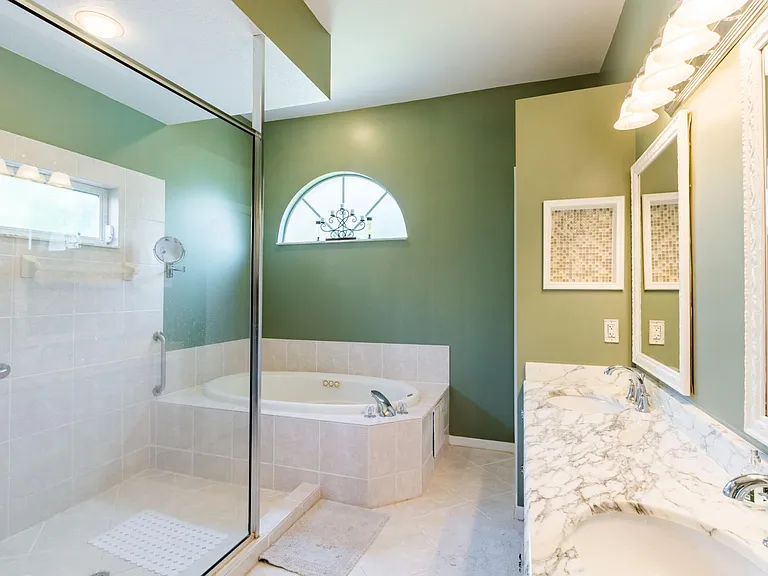 Oversized shower, jacuzzi and double sink vanity.