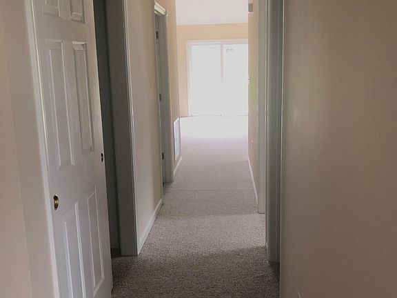 Front hall leads to living area, kitchen, and master suite