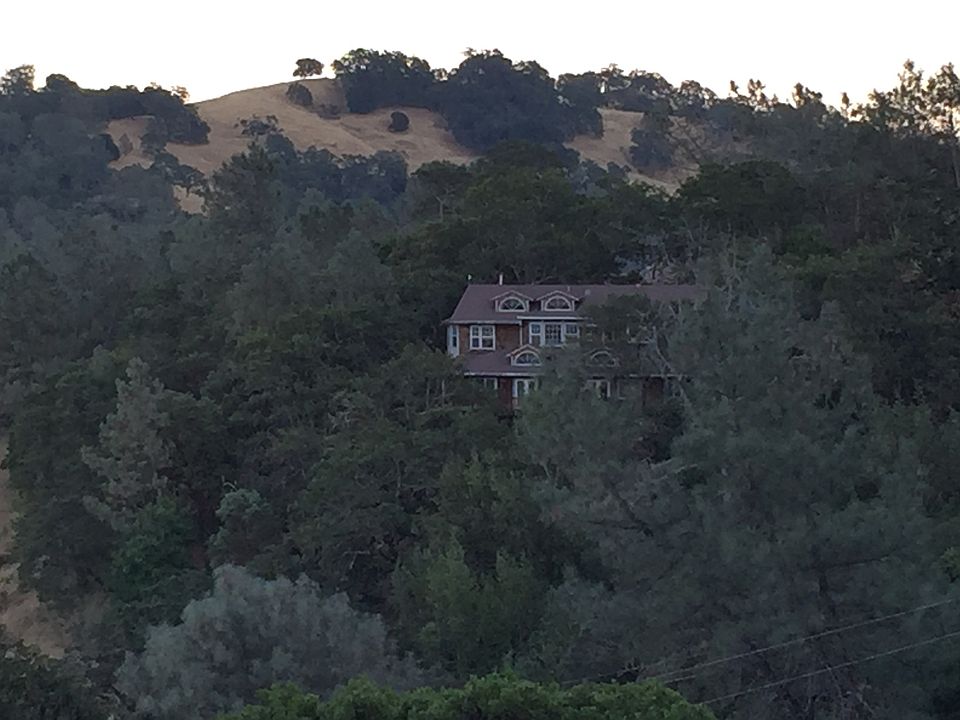 Outside of 3 story home, 2 floors with balconies