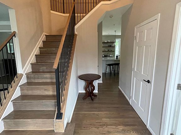 Entryway with den/office bonus room to right and living room to left
