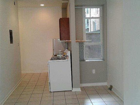 Galley style kitchen with mosaic tile backsplash