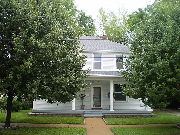Mature trees shade the porch and give privacy.