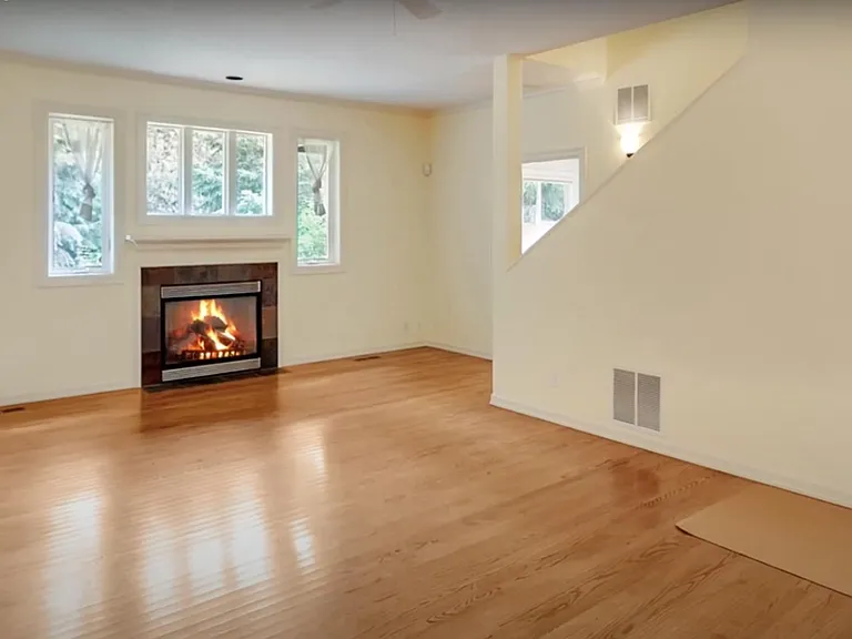 Spacious living room with hardwood floors and cozy fireplace