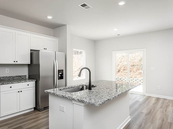 The luxurious kitchen seamlessly connects to the spacious living area.