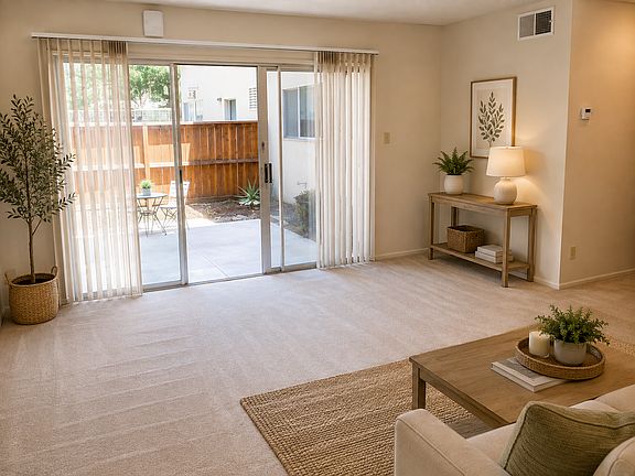 Spacious living room with sliding glass doors leading to a private patio.