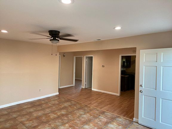 Spacious living room with recessed light and Fan