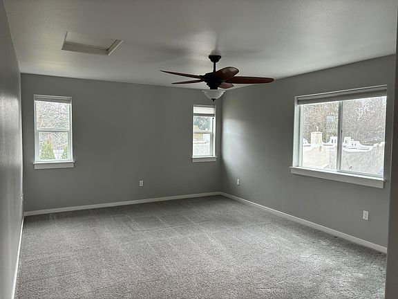 Very Large bedroom with ceiling fan and privacy.