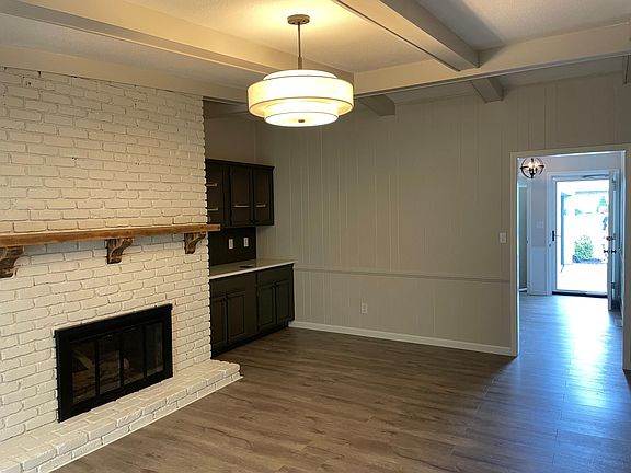 Family Room with high ceiling, gas fireplace, and bar or storage cabinetry