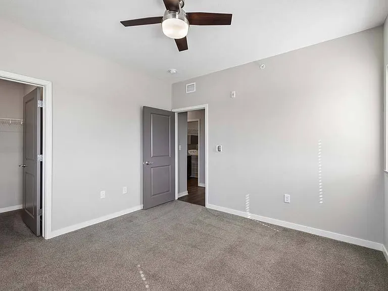 Retreat to a spacious bedroom where clean lines, generous proportions, and a calming atmosphere create a space you'll love coming home to.