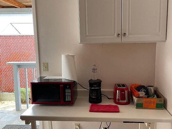 fixed table for microwave etc. notice cabinet above for storage.