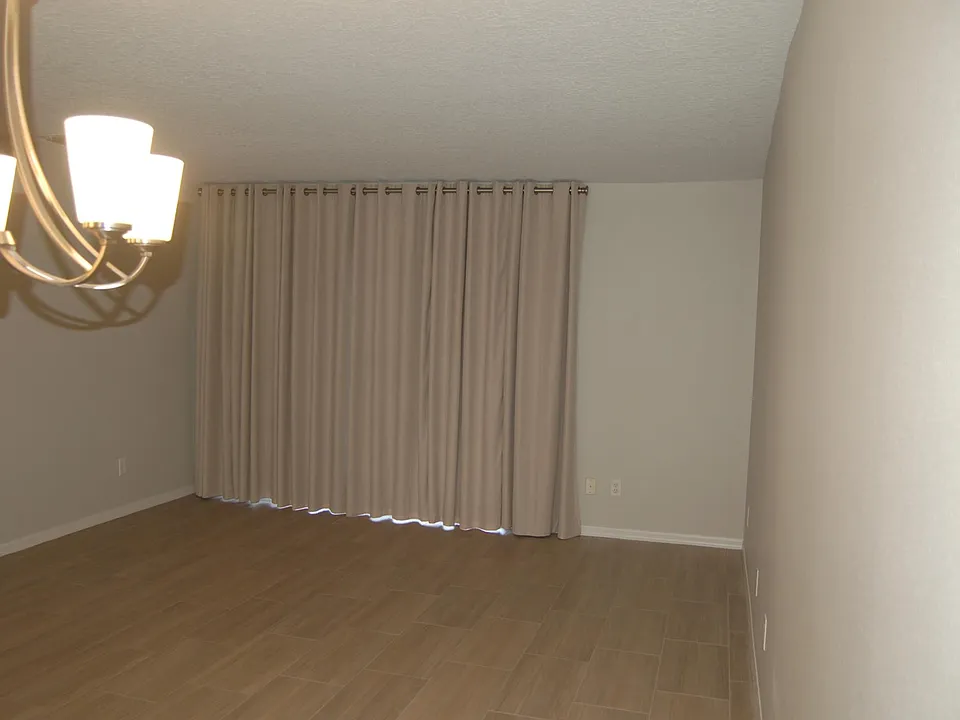 Dining and Living Room with Floor to Ceiling Drapes