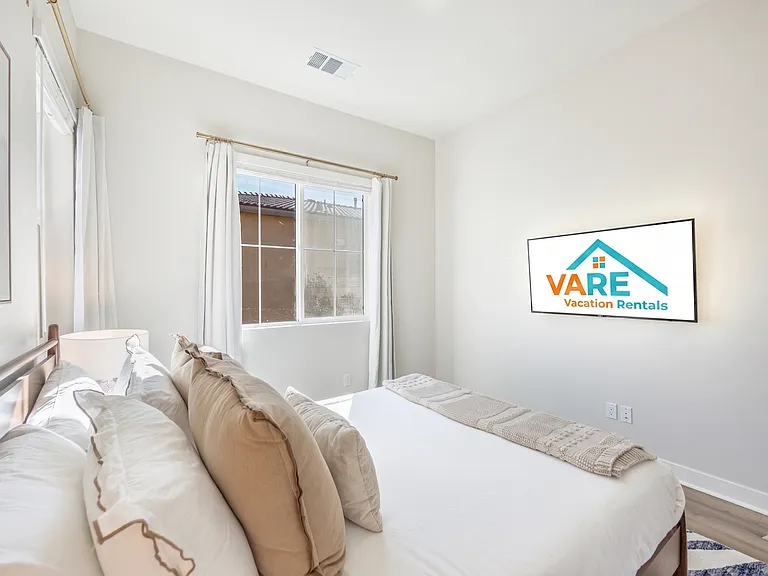 Bedroom 3 is filled with natural light and offers a Queen-size bed, a wall-mounted smart TV, and a generously sized mirrored reach-in closet!