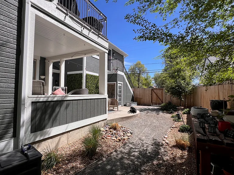 Backyard showing covered porch, patio and balcony off the main bedroom