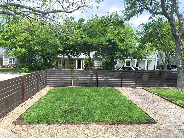 Front yard and privacy fence and 2 lockable gates. View from house to street.