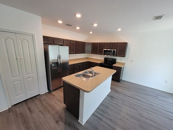Large open kitchen with SS appliances and recessed lighting
