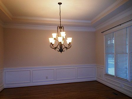 Formal dining room on the front with heavy molding and chandelier