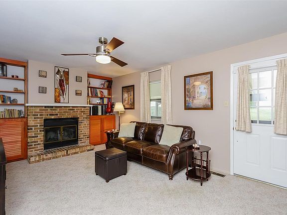 Cozy family room with woodburning fireplace and built-in shelves