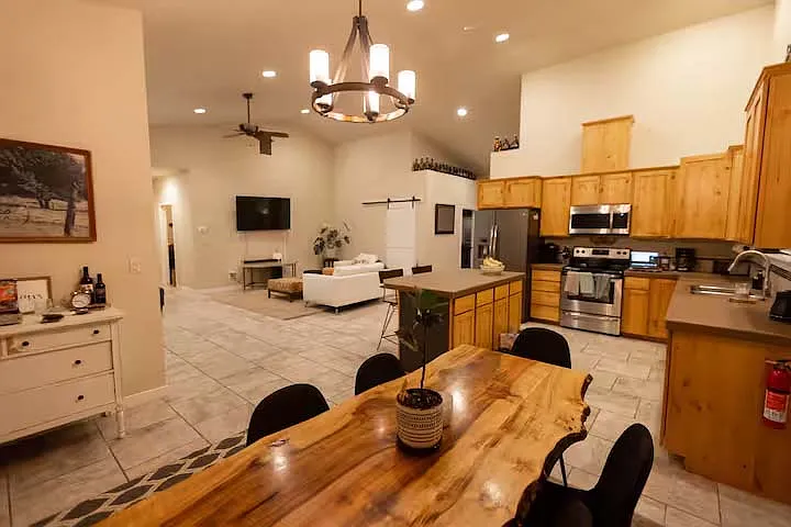 Dining room region with views of kitchen and living room