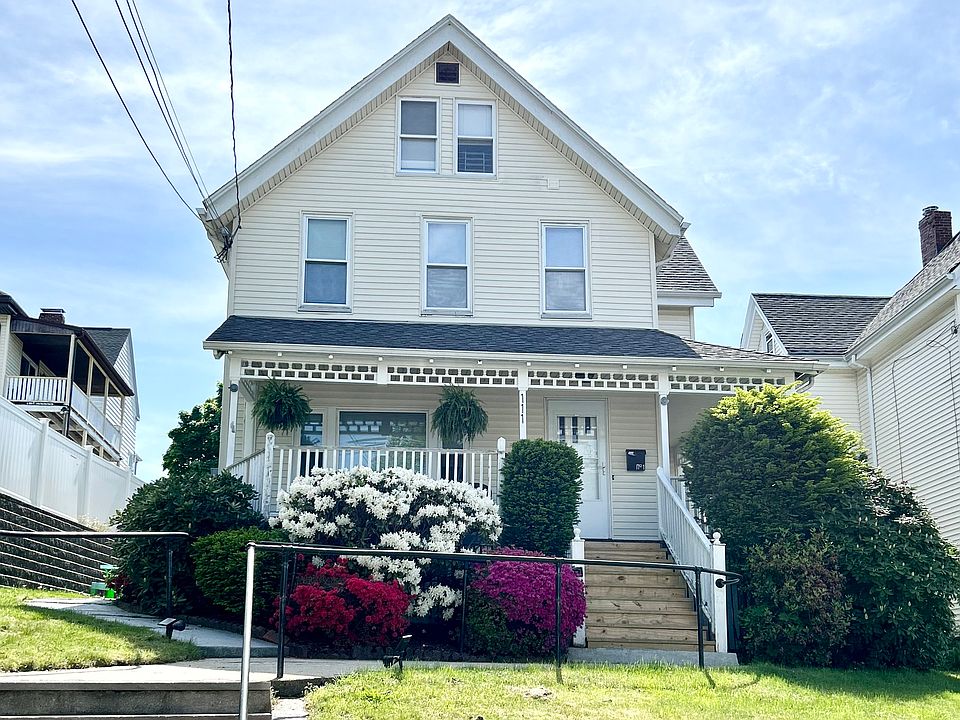 Front entry with porch and landscaped shrubs