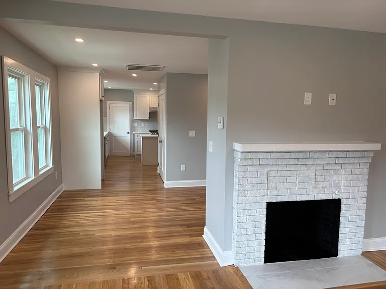 Living Room - Refinished hardwood floors, new insulation, new doors, new windows, new sheetrock, and new electrical.