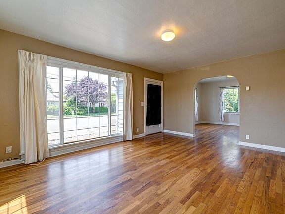 The floor to ceiling window makes for a spacious living room.