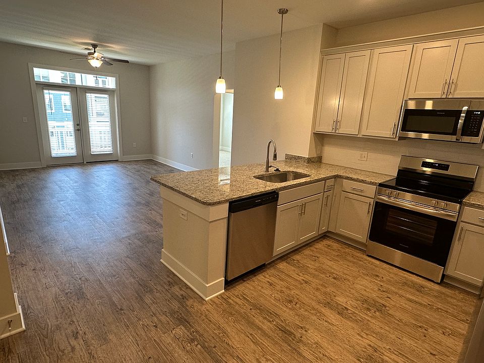 Kitchen with breakfast bar open to living room