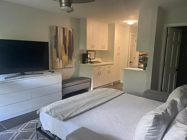 Queen size Murphy bed with a new, memory foam mattress. Very comfortable. Ottoman can double as a coffee table in front of the sofa.