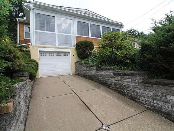 Pull right into your integral garage to get out of the elements and enjoy the openness of the front room with floor to ceiling w