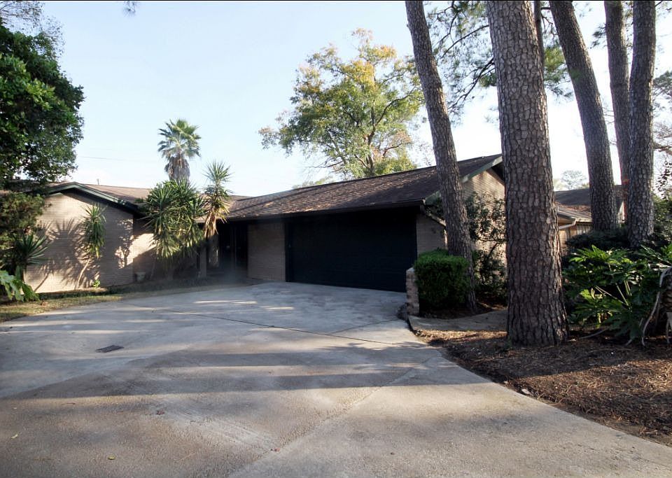 The front of the house has a wonderfully tree-filled lot.