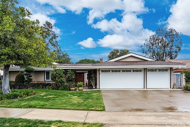 This mid-century ranch style home has great curb appeal and a 3-car garage!