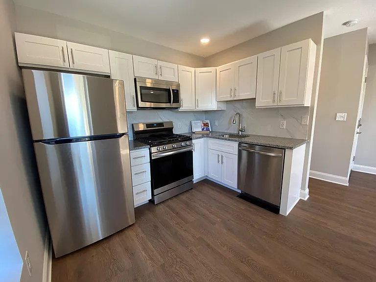 Renovated kitchen with new stainless steel appliances, granite countertops and soft close shaker cabinets