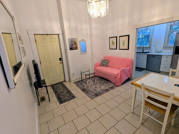 Looking from the hall into the living/dining area, kitchen is beyond on the right.