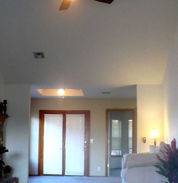 Living room with vaulted ceiling, remote controlled ceiling fan