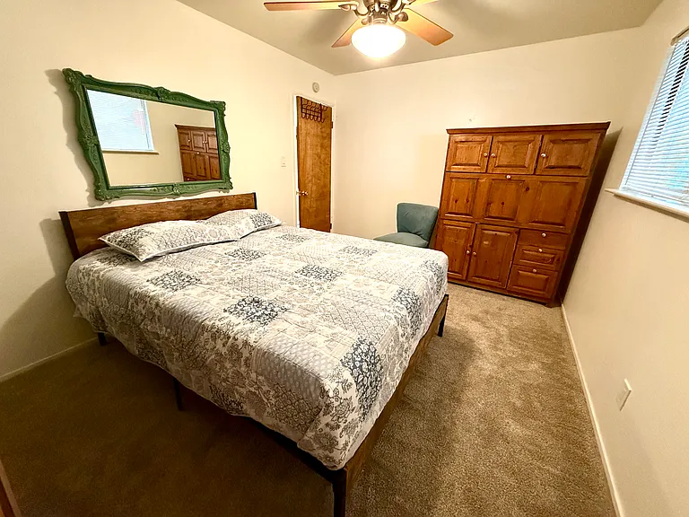 Queen size bed, large closet and a fold down desk cabinet
