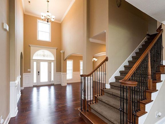 Dramatic entryway featuring soaring ceilings with a beautiful large window.