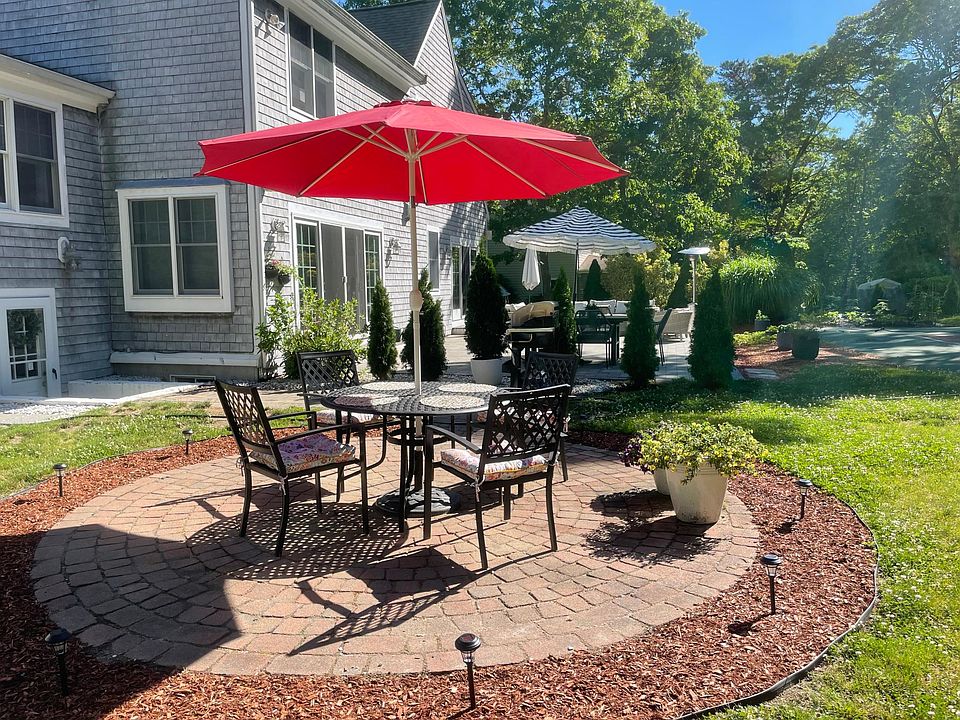 Backyard with table and chairs and gas grill