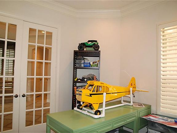 Study with plantation shutters, neutral tones, lots of light....