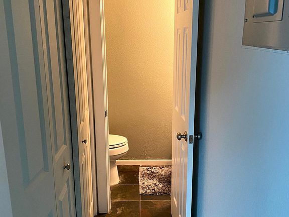 Downstairs 1/2 bath with utility closet and washer/dryer to the left