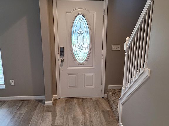 Large open front foyer/entry features new Shaw water proof extremely durable vinyl plank flooring