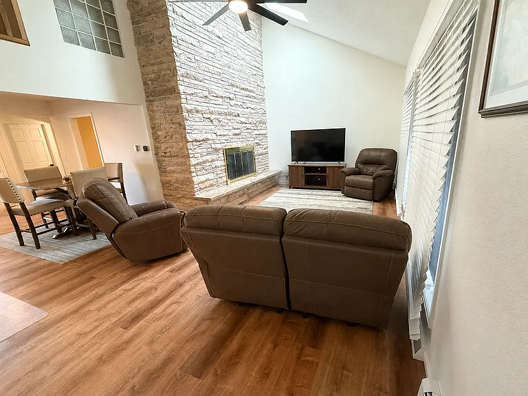 Living room off of dining area with access to back yard.