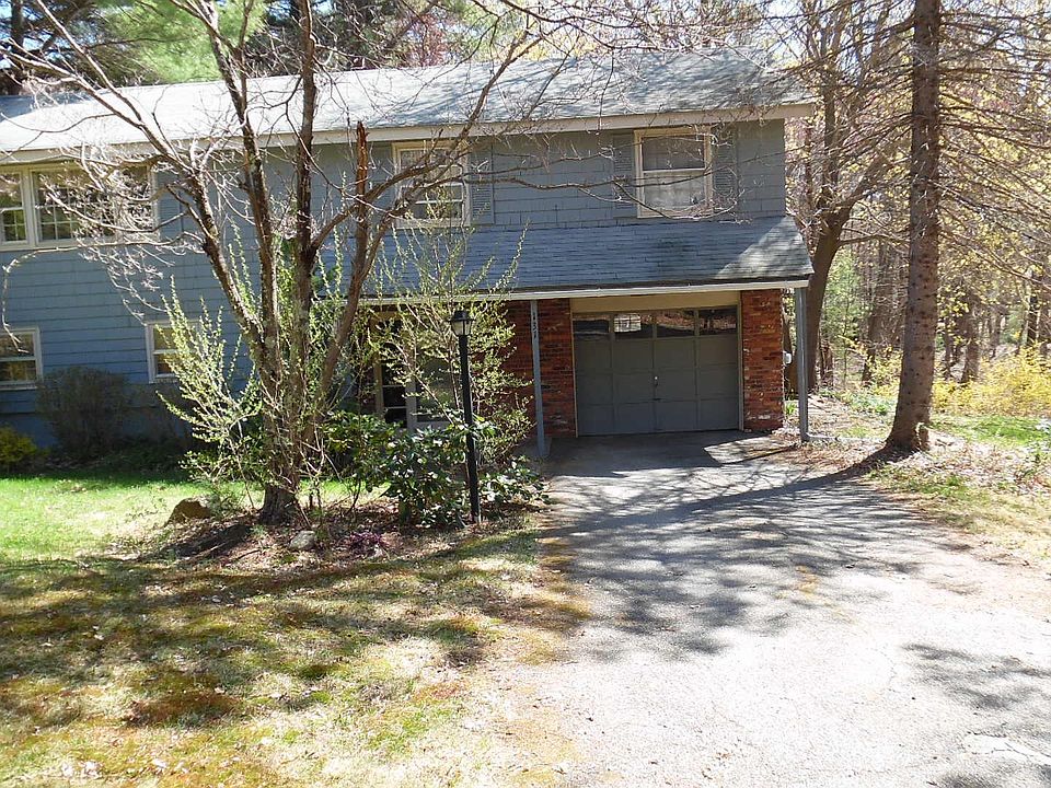 front of raised ranch house on 1 acre