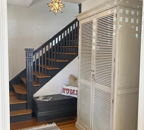 Front door foyer with armoire for personal belongings.