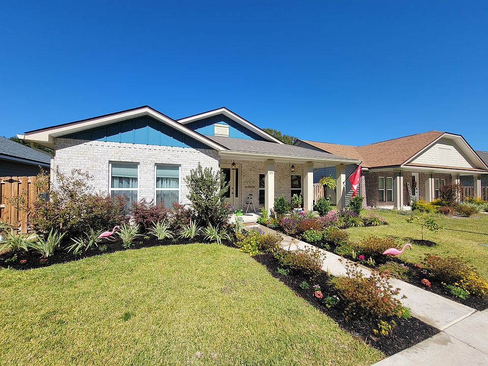Front of home, beautiful walkway, and filled with butterflies &hummingbirds late summer.