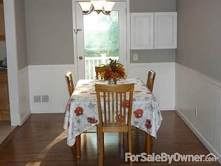 Dining Room
						:
						Hardwood floor, wainscoting, chandelier, crown molding