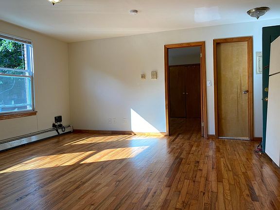 Open kitchen-dining-living room -- looking to bedroom 1 & bathroom