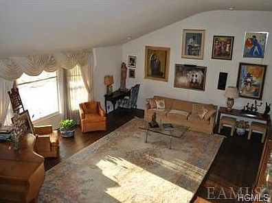 Large, bright living room with high ceilings and picture window